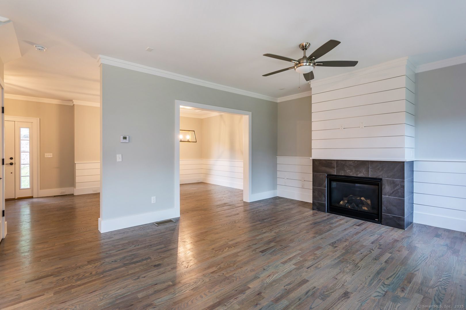 Lot1 Deerwood Road Oxford, CT 06478 - Photo 25 of 33 a view of a livingroom with wooden floor and a ceiling fan