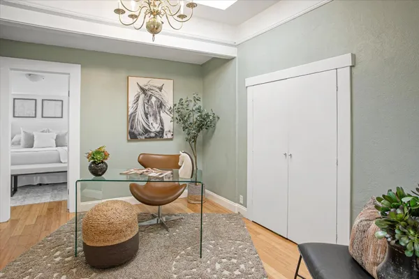 a living room with furniture and a chandelier