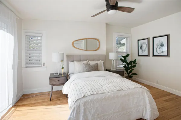 a bedroom with bed and a potted plant