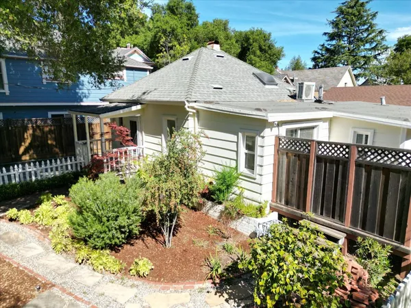 an aerial view of a house with a yard and garden