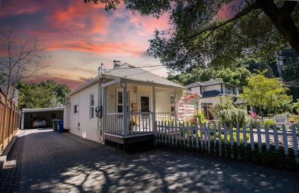 a front view of a house with garden