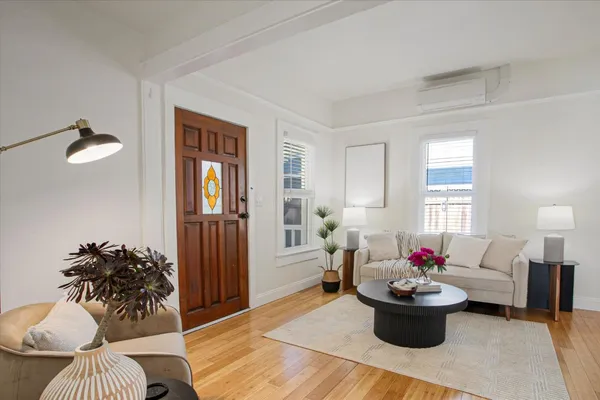 a living room with furniture and a potted plant