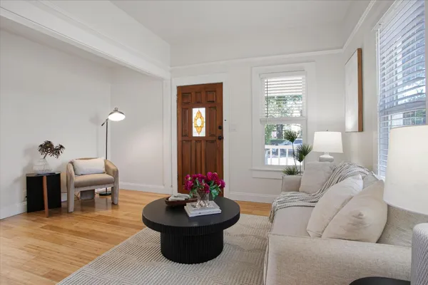 a dining room with furniture potted plants and wooden floor