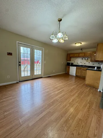 a view of a livingroom with furniture wooden floor and chandelier