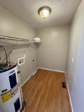 a view of a room with wooden floor