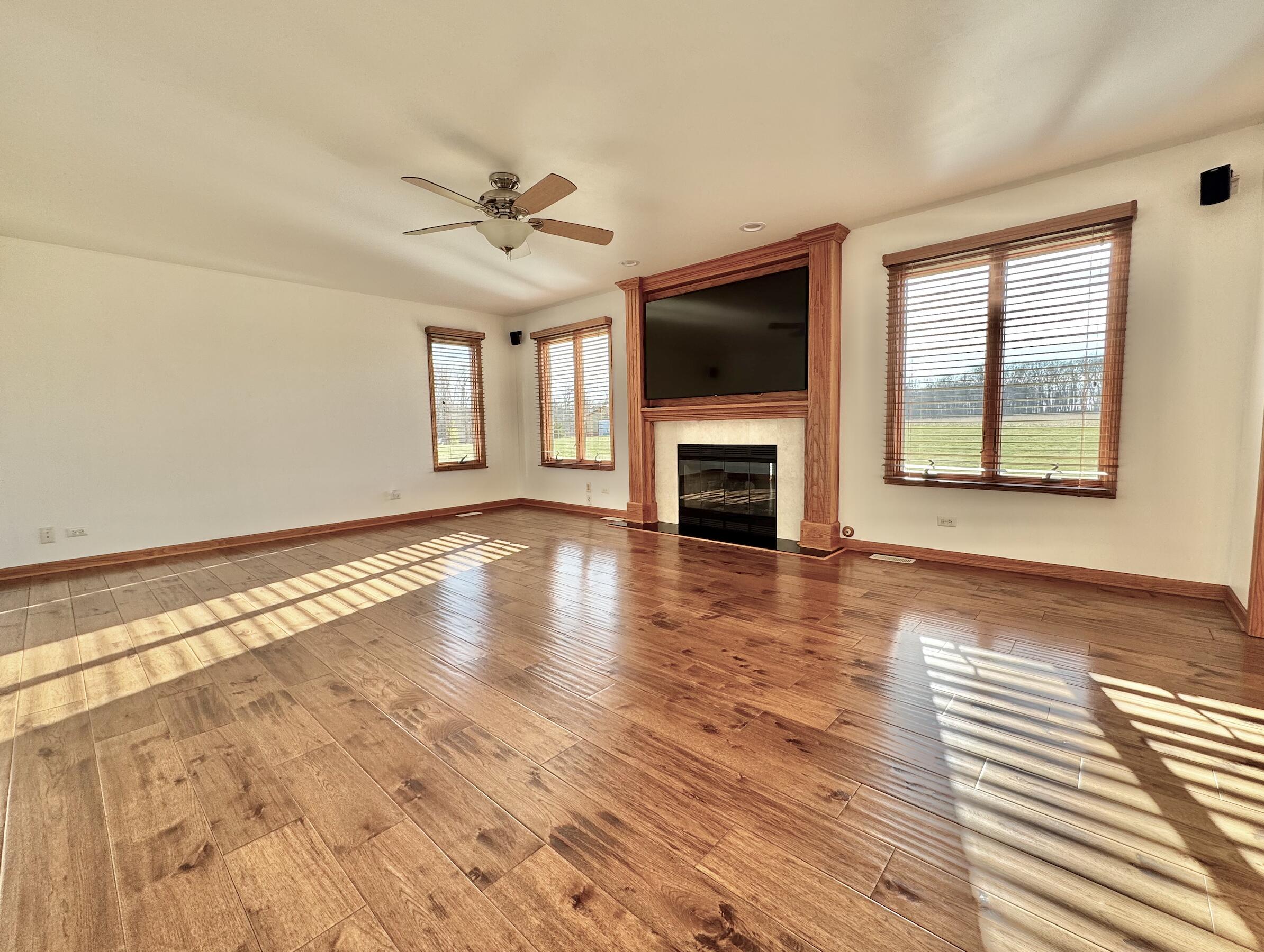 17826 South County Line Road Hebron, IN 46341 - Photo 6 of 67 a view of an empty room with wooden floor fireplace and a window