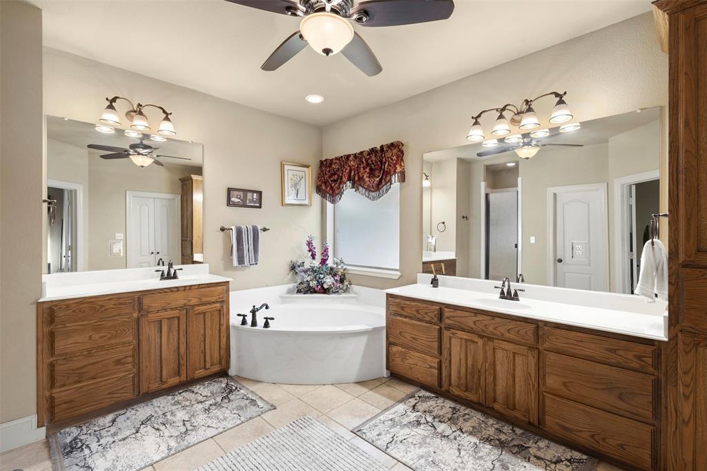 105 Country Ridge Court Red Oak, TX 75154 - Photo 22 of 40 a spacious bathroom with a double vanity sink mirror and a bathtub