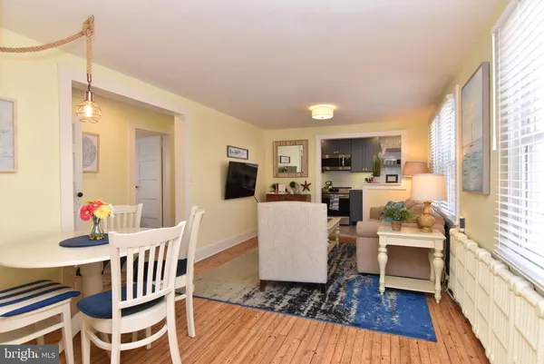 a view of a dining room with furniture wooden floor and chandelier