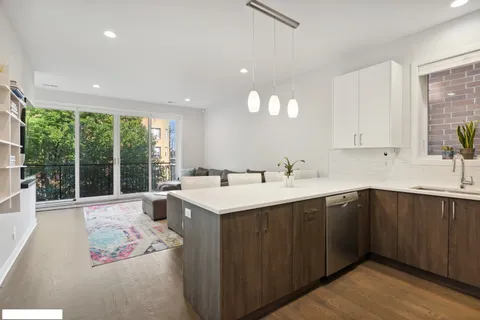 a kitchen with a sink and large window