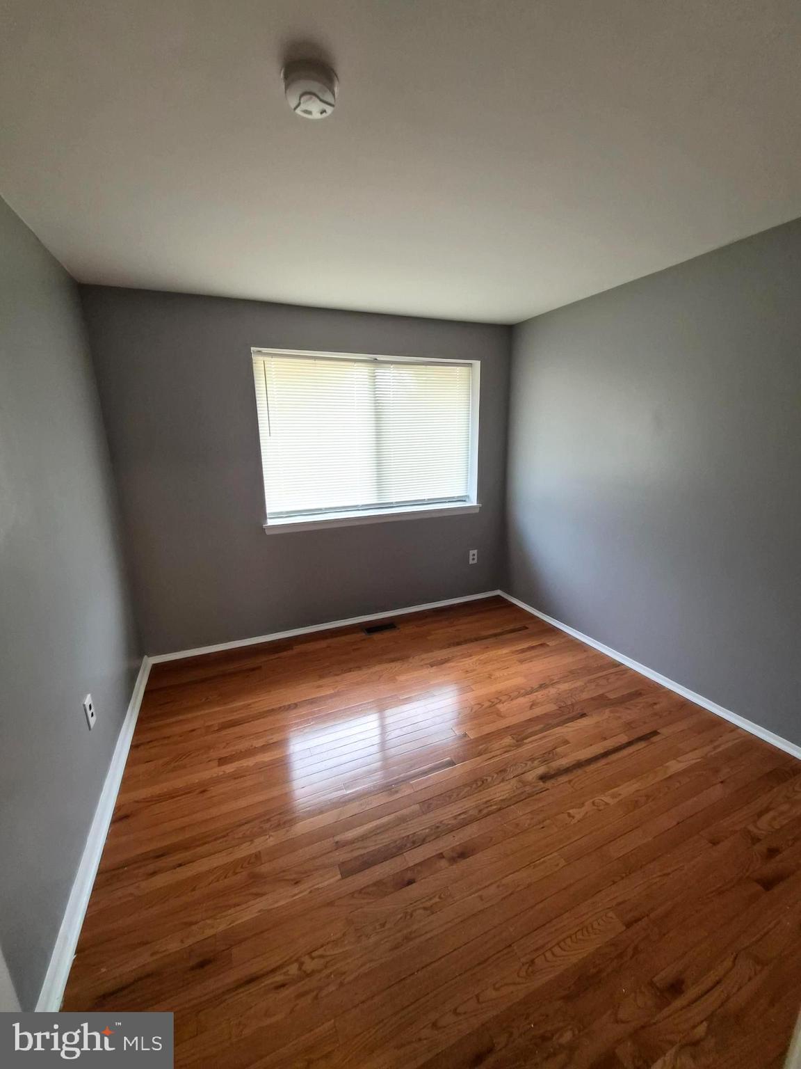 7120 Winter Rose Path Columbia, MD 21045 - Photo 15 of 28 an empty room with wooden floor and windows