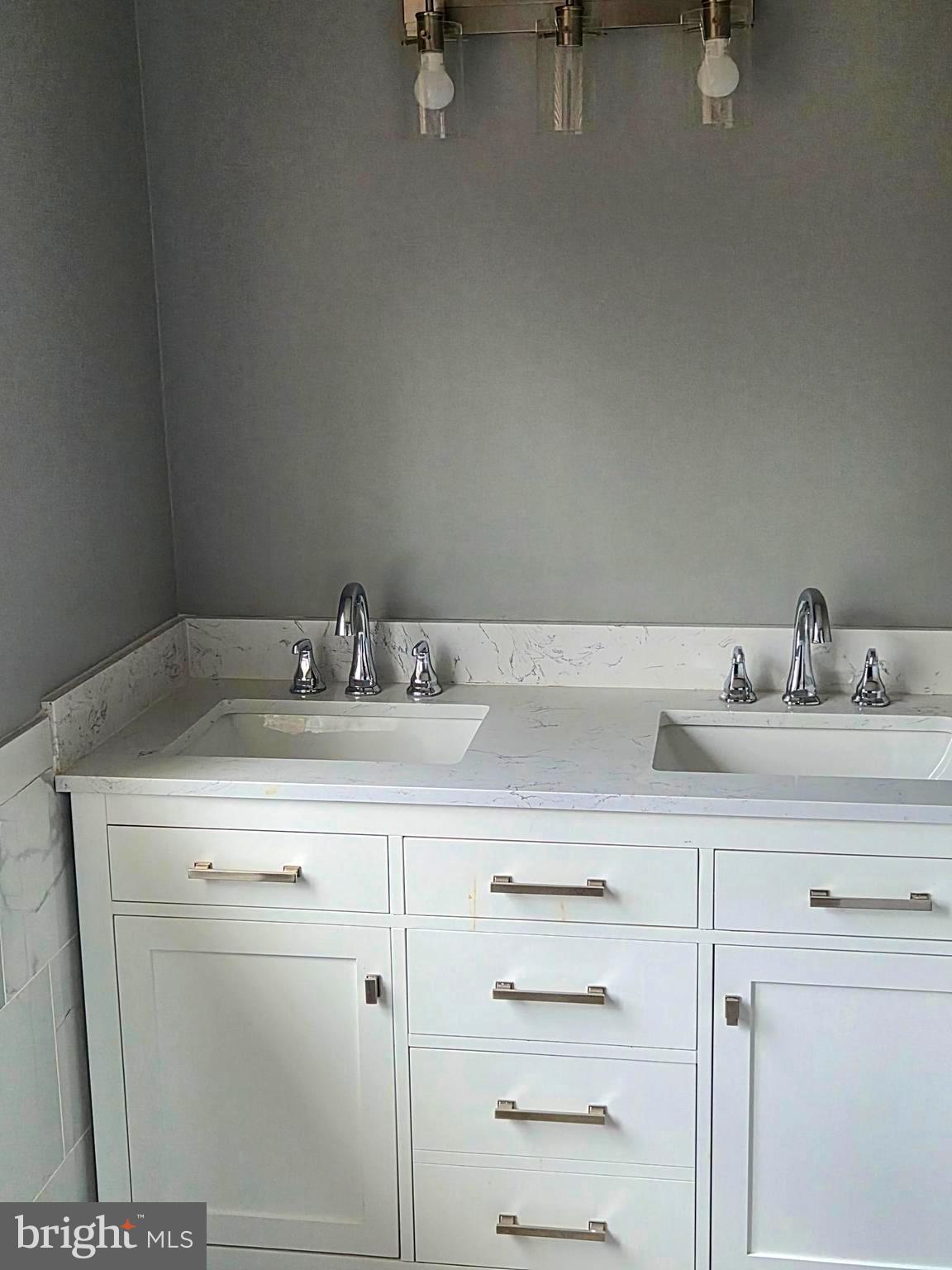 7120 Winter Rose Path Columbia, MD 21045 - Photo 19 of 28 a bathroom with a sink and a mirror