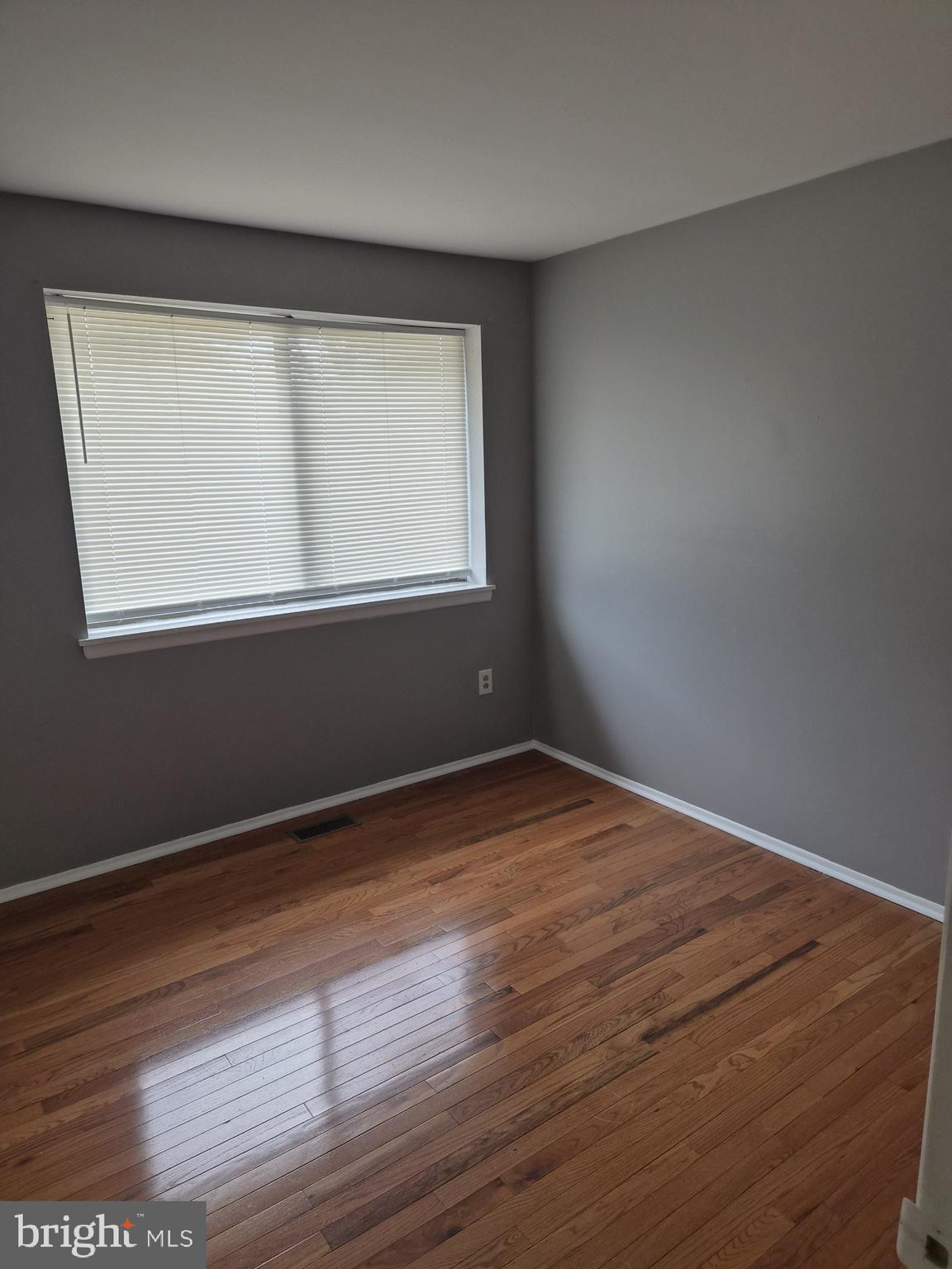 7120 Winter Rose Path Columbia, MD 21045 - Photo 22 of 28 an empty room with wooden floor and windows