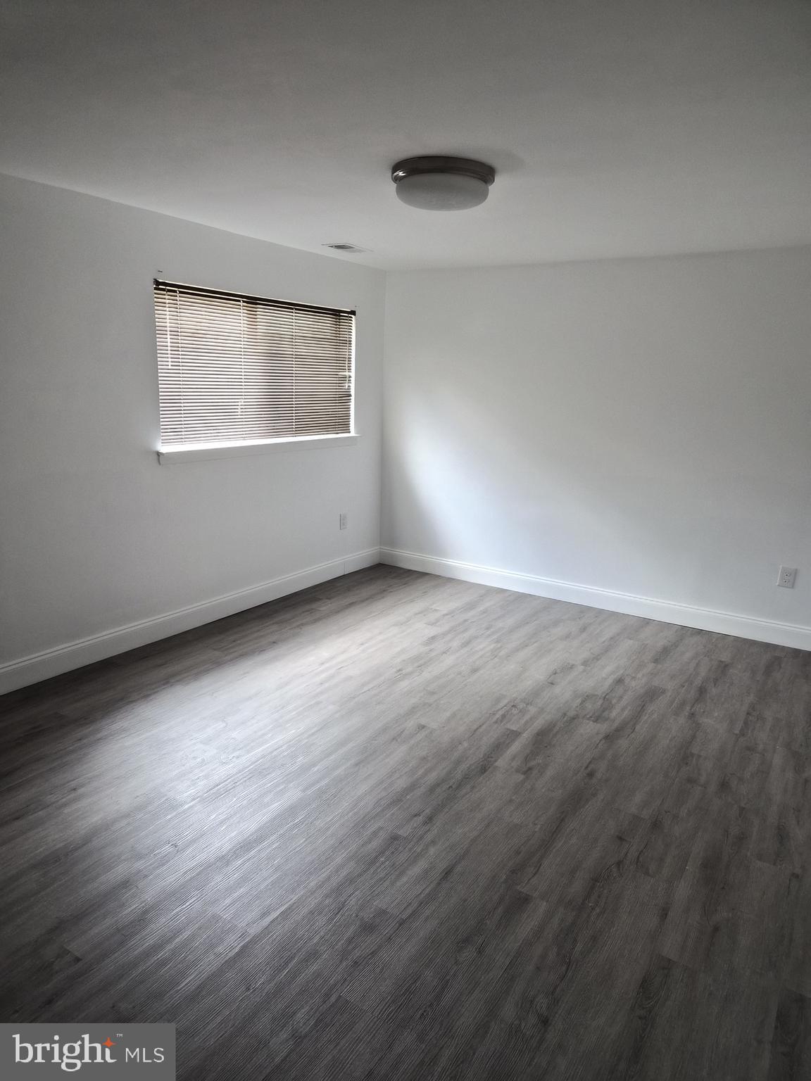 7120 Winter Rose Path Columbia, MD 21045 - Photo 23 of 28 an empty room with wooden floor and windows