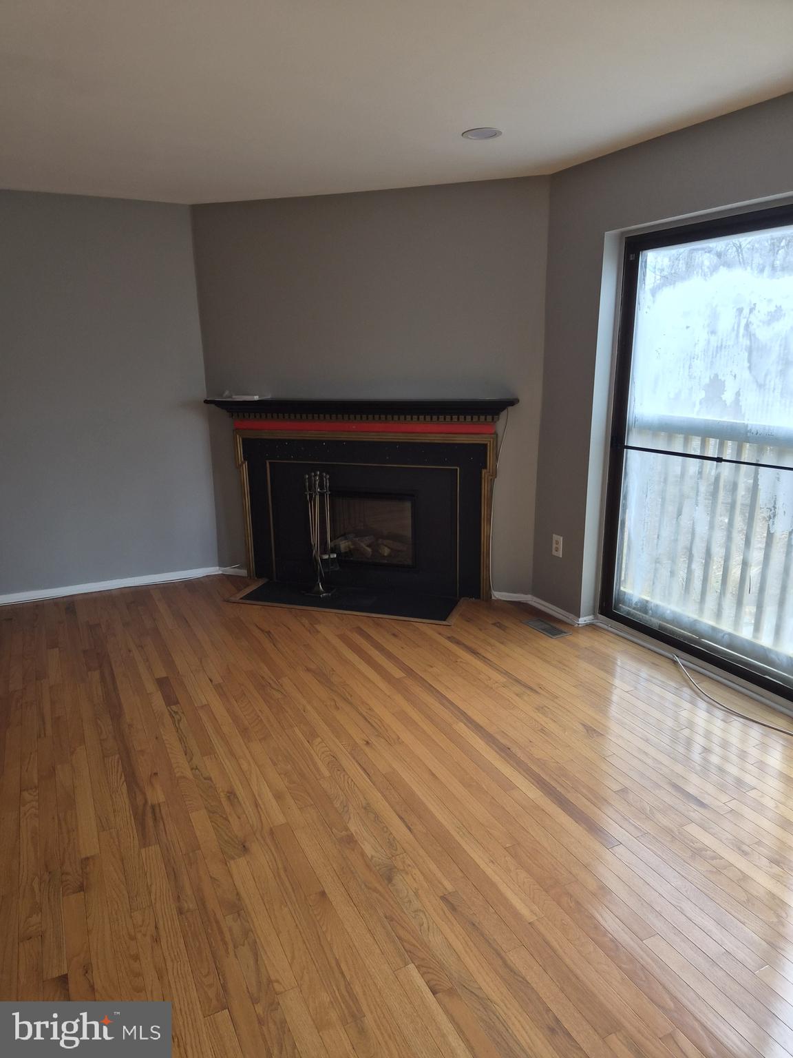 7120 Winter Rose Path Columbia, MD 21045 - Photo 9 of 28 a view of empty room with wooden floor and fan