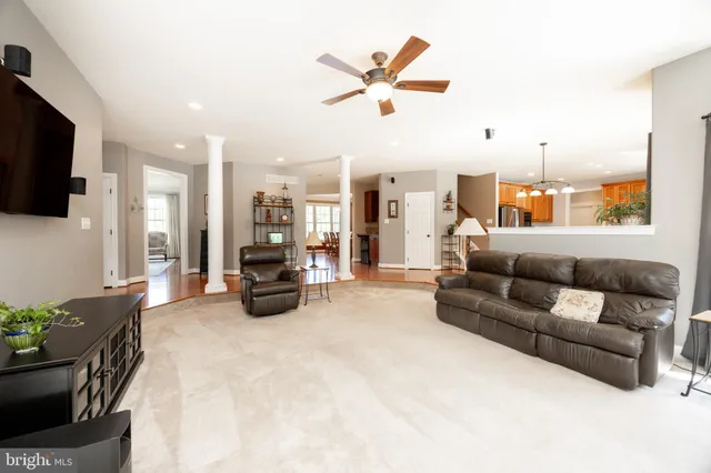 a front view of a house with a yard and trees