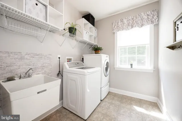 a front view of a house with yard and green space