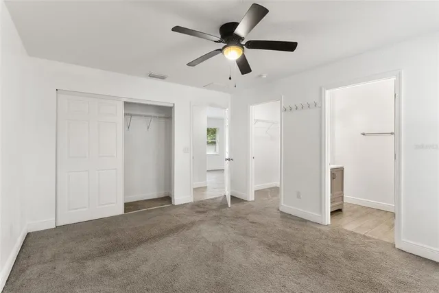 a view of empty room with ceiling fan