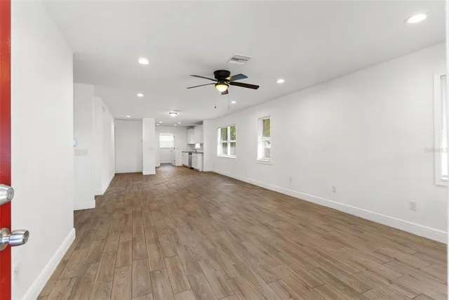 wooden floor in an empty room with a window
