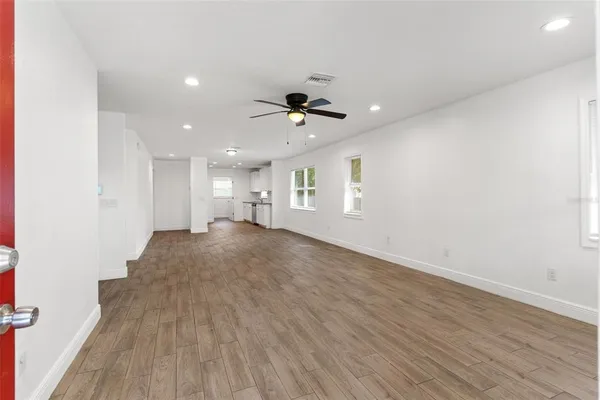 wooden floor in an empty room with a window