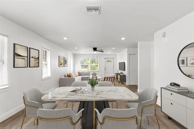 a view of a dining room with furniture and wooden floor