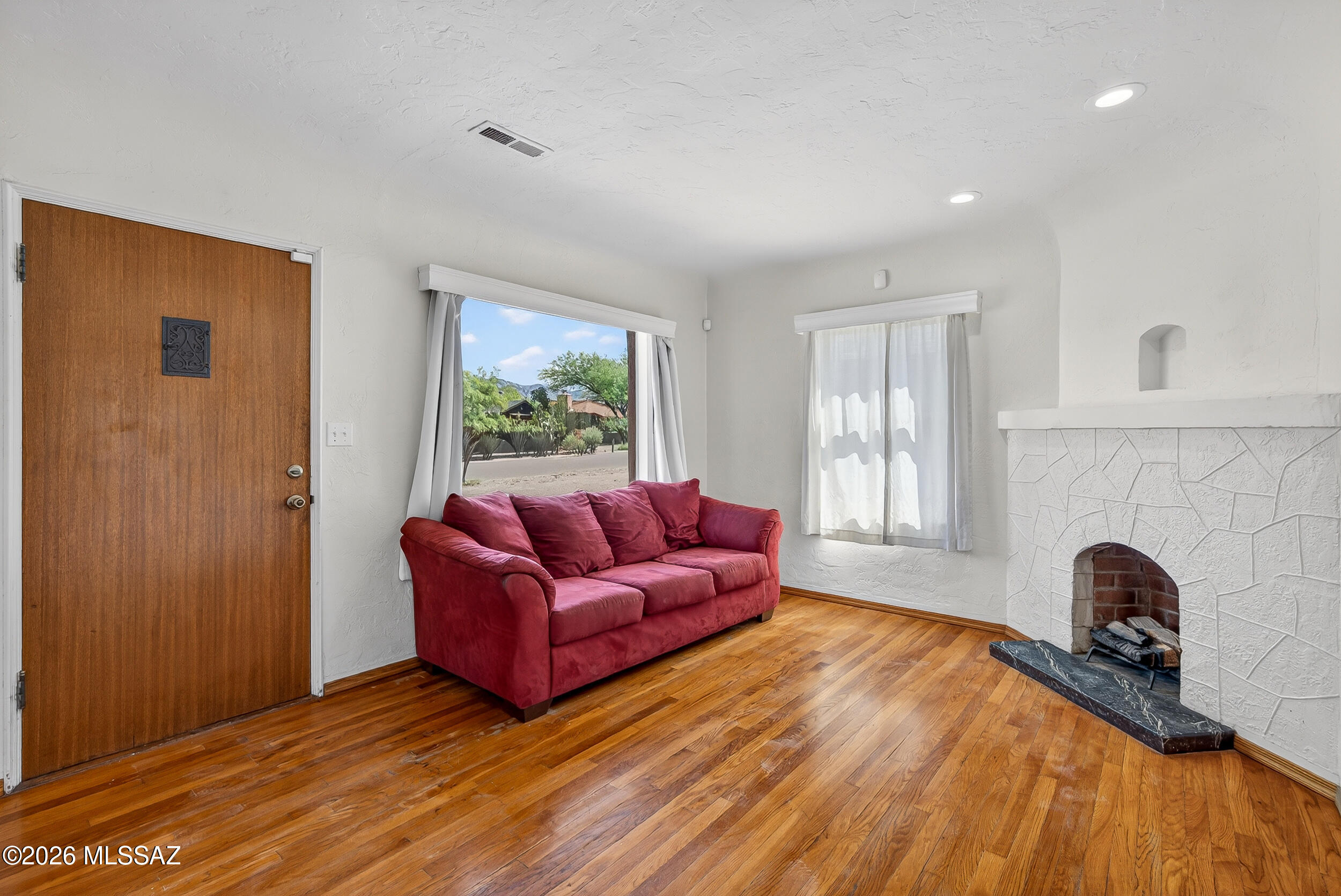 1412 East Spring Street Tucson, AZ 85719 - Photo 13 of 43 a living room with furniture and a fireplace