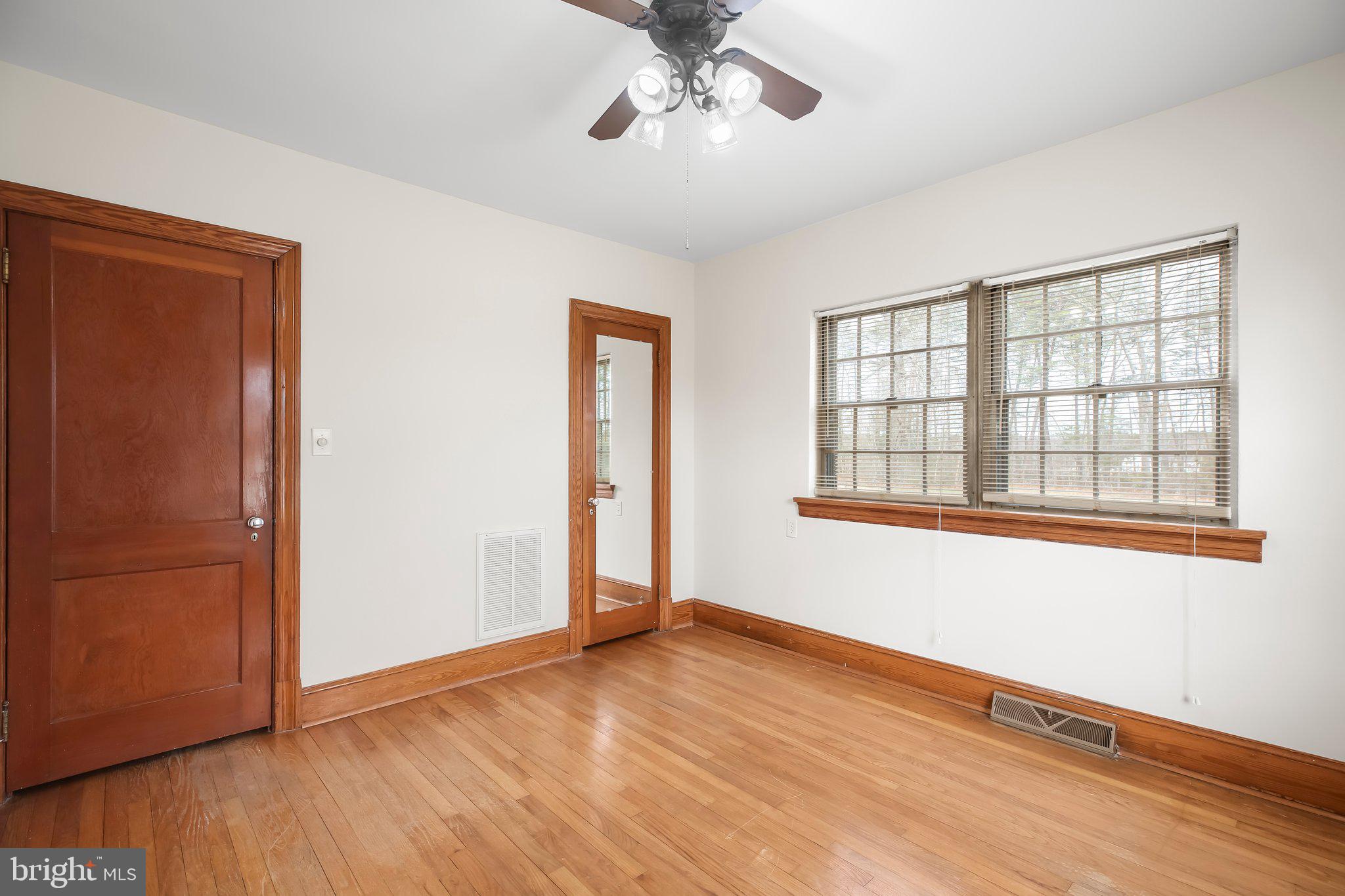 19192 Partlow Road Beaverdam, VA 23015 - Photo 10 of 26 a view of an empty room with wooden floor and a window