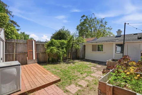a backyard of a house with table and chairs