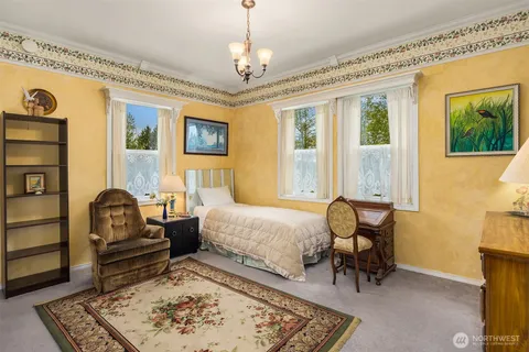 a bedroom with furniture and a window