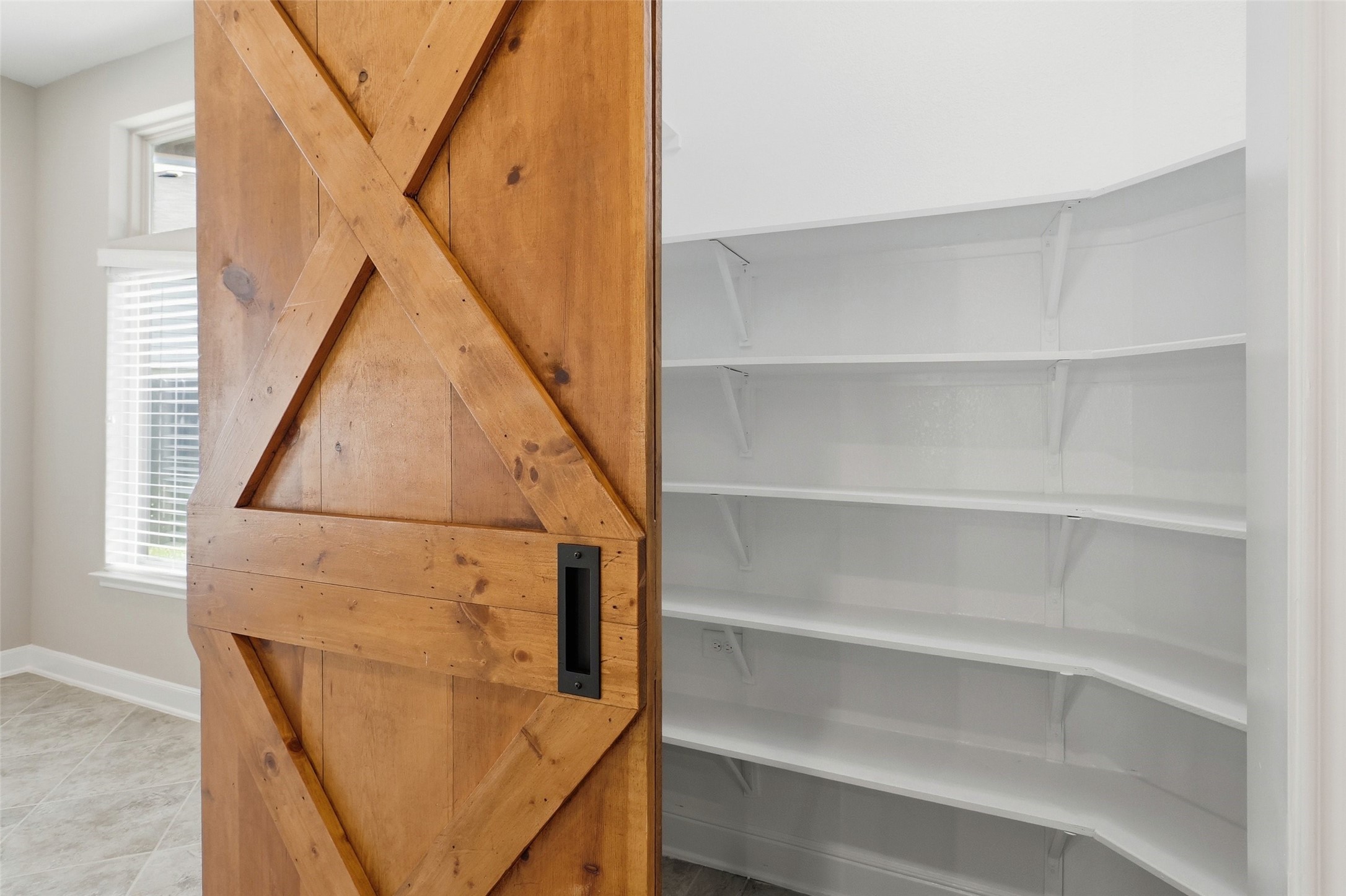 24126 Cane Fields Road Katy, TX 77493 - Photo 9 of 36 Walk-in pantry provides exceptional storage and everyday convenience, with a sliding barn door