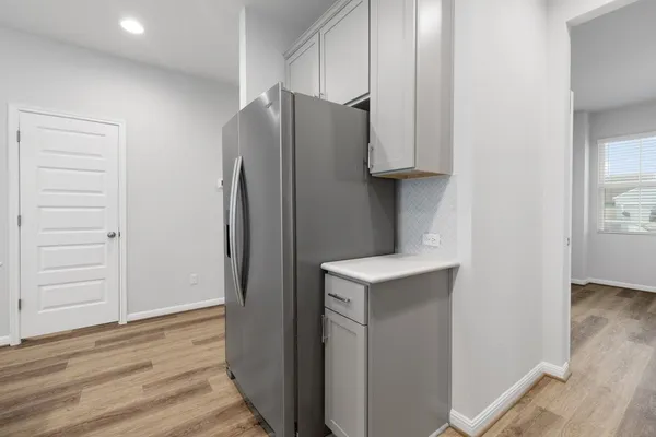 a kitchen with a refrigerator and a sink