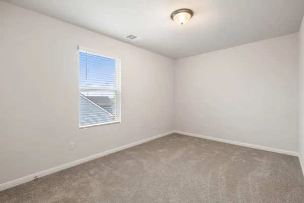an empty room with closet area