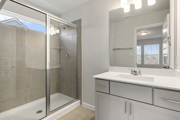 a bathroom with a shower and a sink