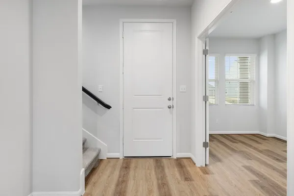 an empty room with wooden floor and a window