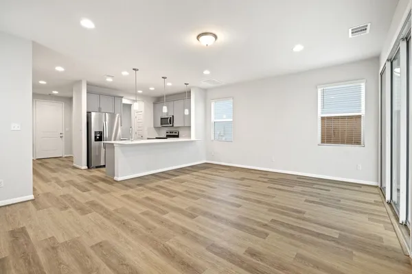 a view of a kitchen with a sink and a refrigerator