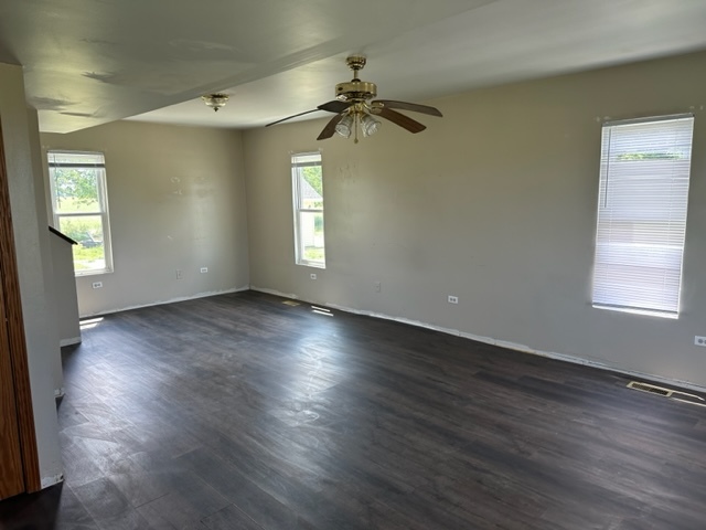741 Sterling Road Dixon, IL 61021 - Photo 2 of 21 an empty room with wooden floor fan and windows