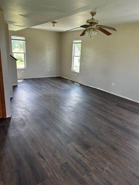 741 Sterling Road Dixon, IL 61021 - Photo 3 of 21 an empty room with wooden floor fan and windows