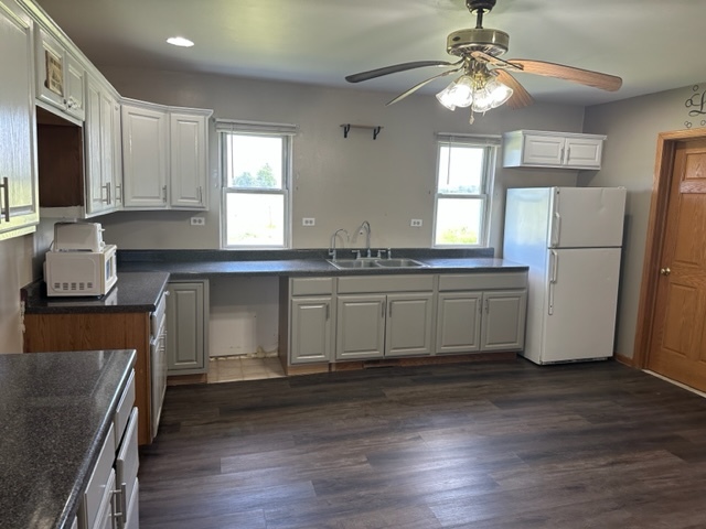 741 Sterling Road Dixon, IL 61021 - Photo 5 of 21 a kitchen with stainless steel appliances granite countertop a sink a stove a refrigerator cabinets and wooden floor