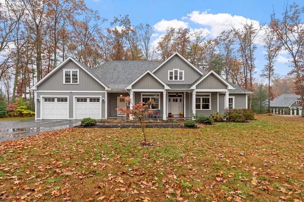 243 Gates Pond Road Berlin, MA 01503 - Photo 1 of 40 a front view of a house with garden