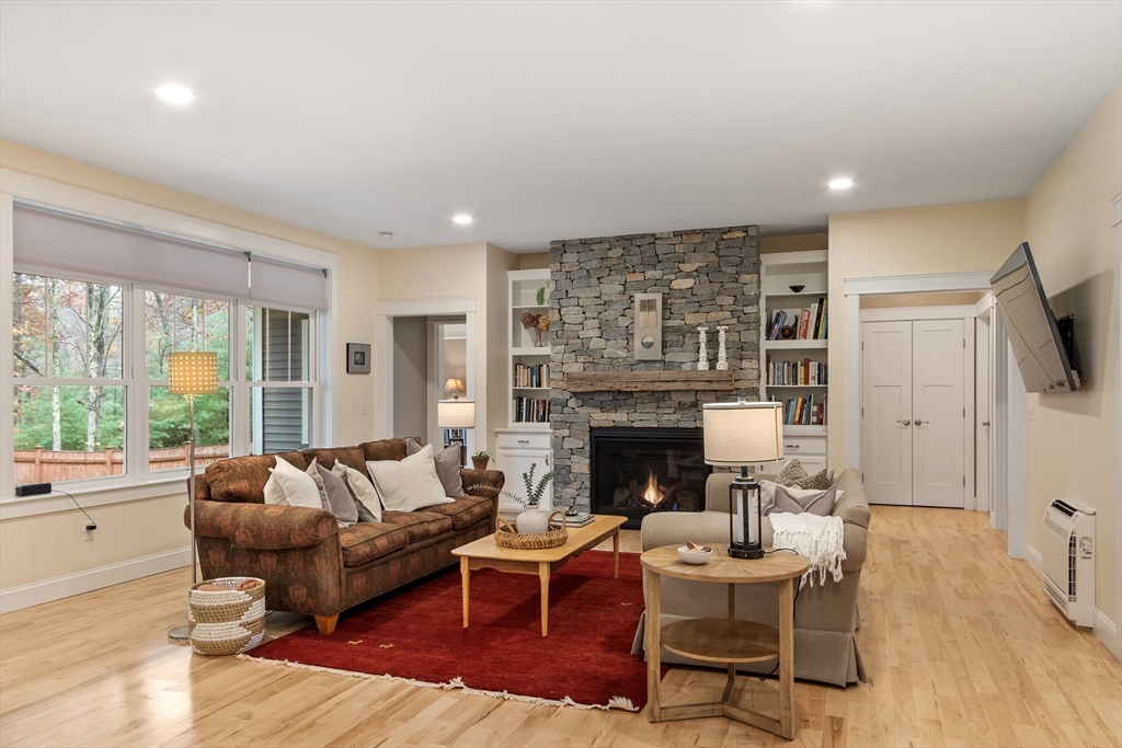 243 Gates Pond Road Berlin, MA 01503 - Photo 13 of 40 a living room with furniture and a fireplace
