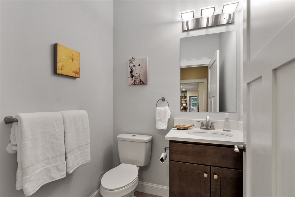 243 Gates Pond Road Berlin, MA 01503 - Photo 20 of 40 a bathroom with a toilet a sink and mirror