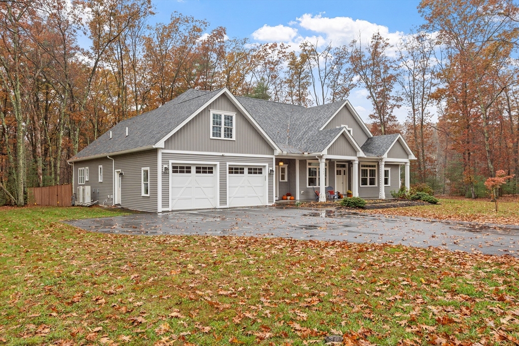 243 Gates Pond Road Berlin, MA 01503 - Photo 2 of 40 a front view of a house with a garden