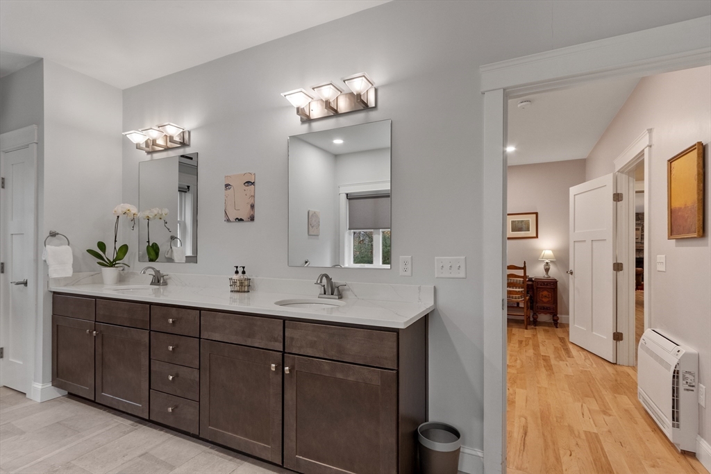 243 Gates Pond Road Berlin, MA 01503 - Photo 23 of 40 a spacious bathroom with double vanity sinks a toilet a mirror and vanity