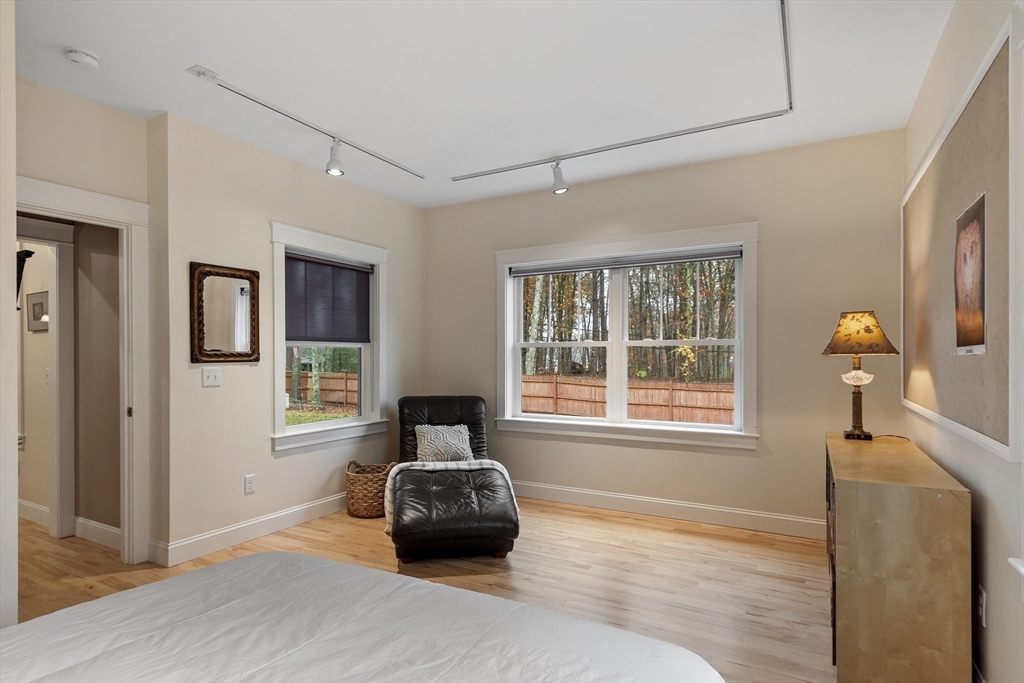 243 Gates Pond Road Berlin, MA 01503 - Photo 32 of 40 a bedroom with a bed and wooden floor