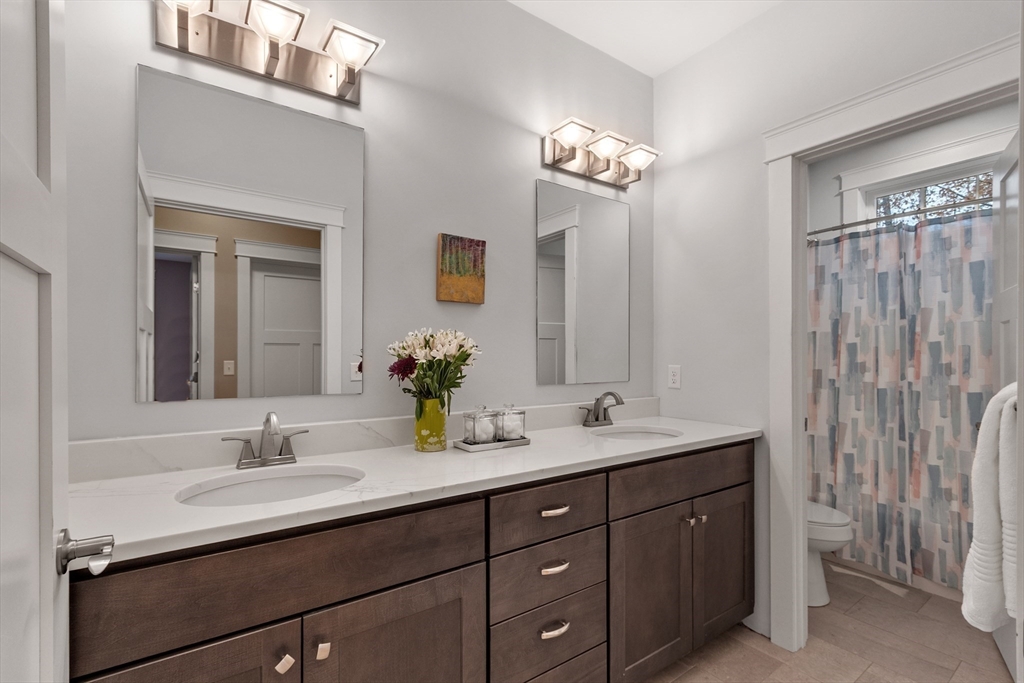 243 Gates Pond Road Berlin, MA 01503 - Photo 33 of 40 a bathroom with double sink and a mirror