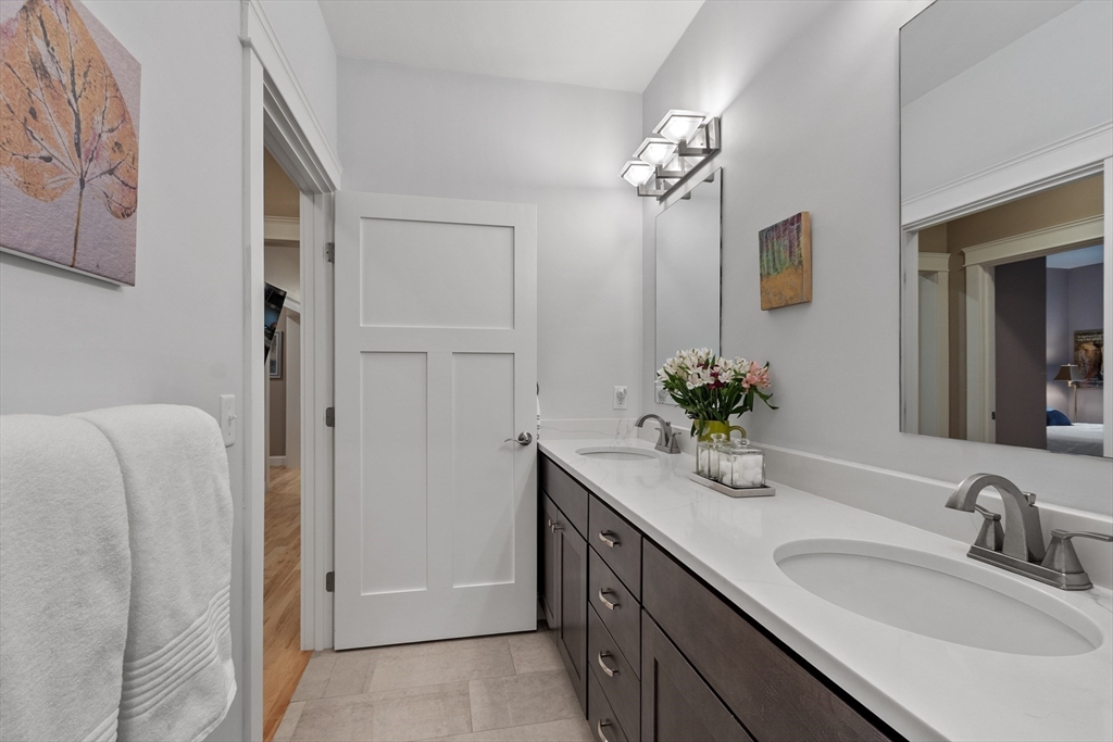 243 Gates Pond Road Berlin, MA 01503 - Photo 34 of 40 a bathroom with a granite countertop sink a large mirror and a shower