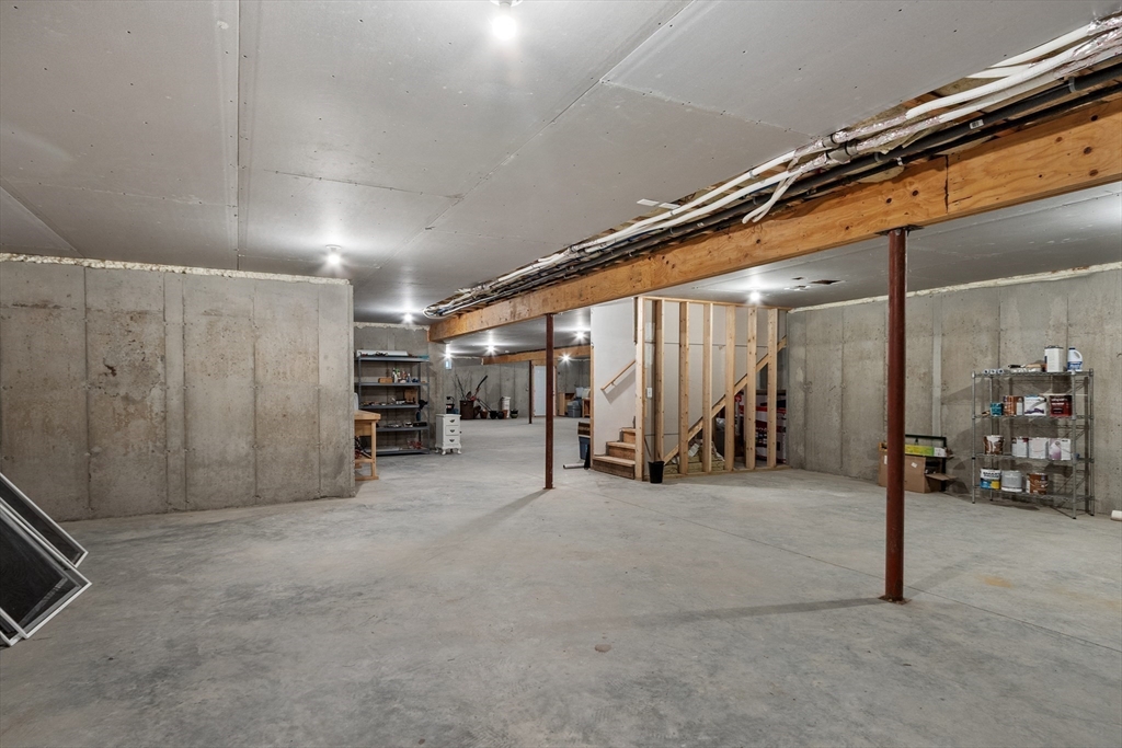 243 Gates Pond Road Berlin, MA 01503 - Photo 35 of 40 a view of an empty room with air conditioner duct and materials on floor