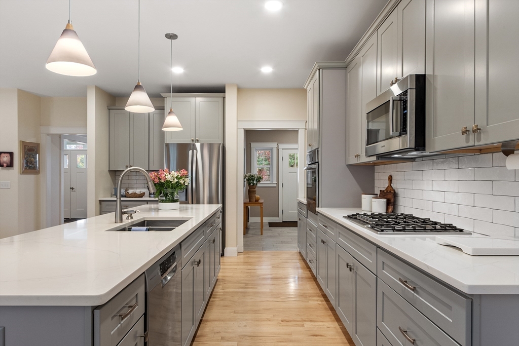 243 Gates Pond Road Berlin, MA 01503 - Photo 7 of 40 a kitchen with stainless steel appliances a sink stove and cabinets