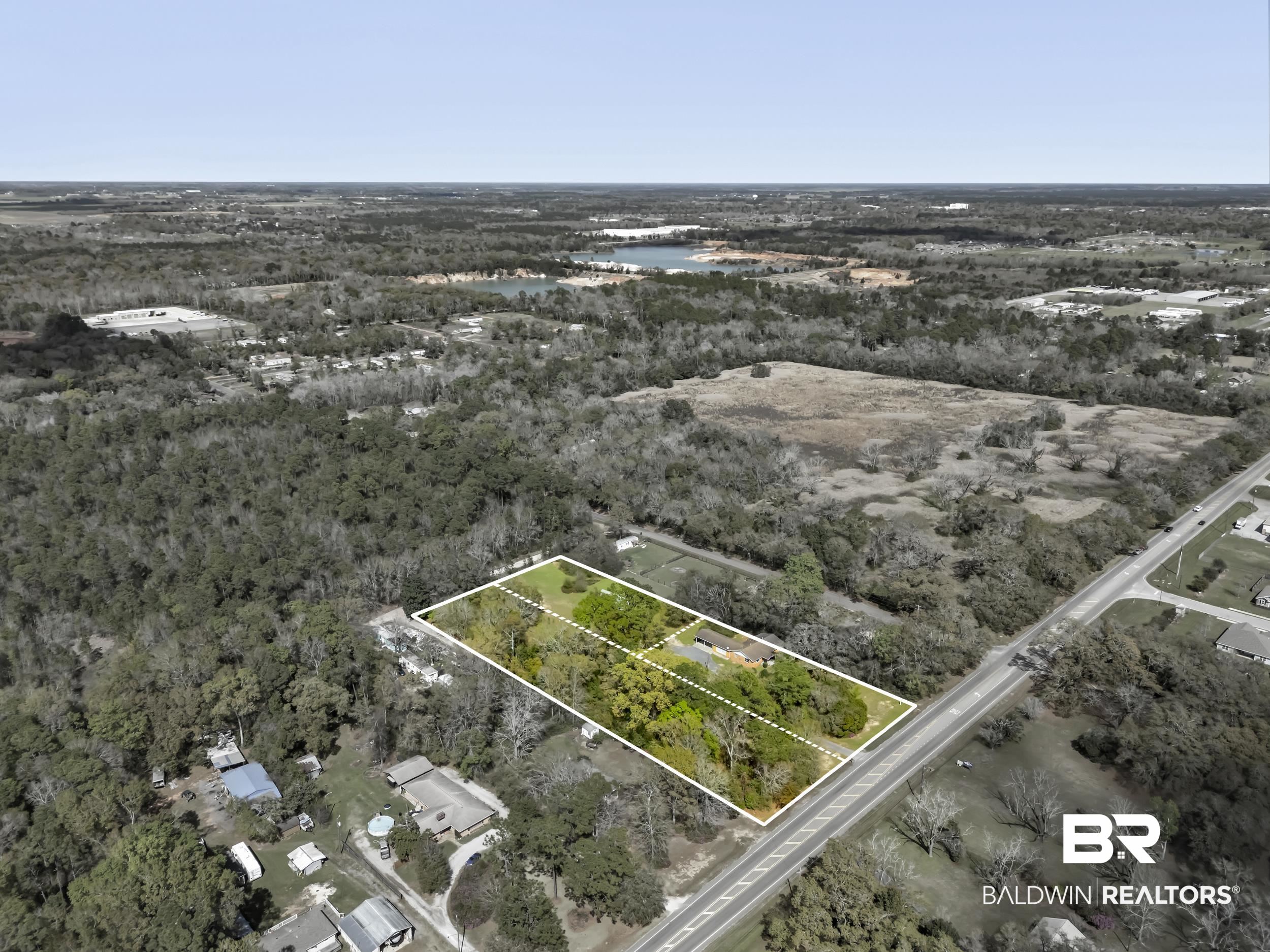 17463 Highway 98 Foley, AL 36535 - Photo 36 of 57 Aerial view of property and surrounding area featuring property parcel outlined and a nearby body of water