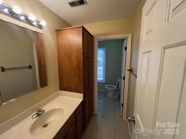 a bathroom with a sink double vanity and a mirror