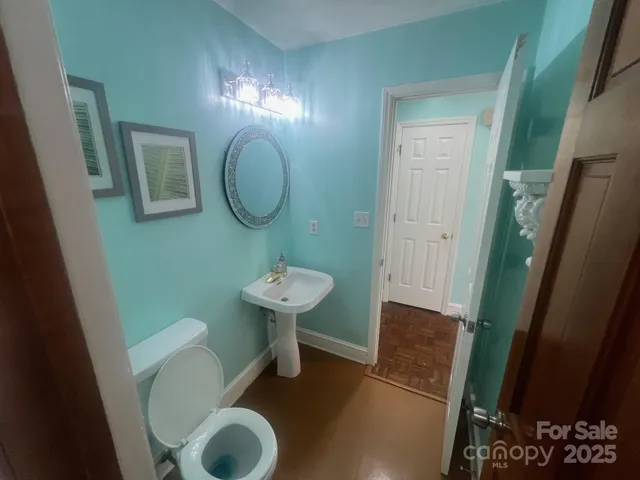 a bathroom with a sink toilet and a mirror